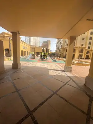 an empty courtyard with a playground in a building at Modern and new studio in Murjan, JBR in Dubai