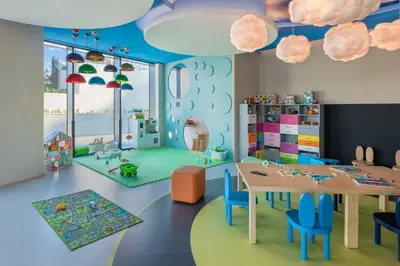 a room with a table and chairs and clouds at Address Beach Resort in Dubai