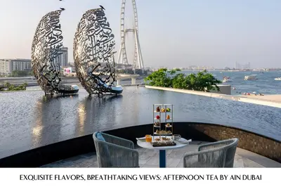 a table on a balcony with a view of a river at Address Beach Resort in Dubai