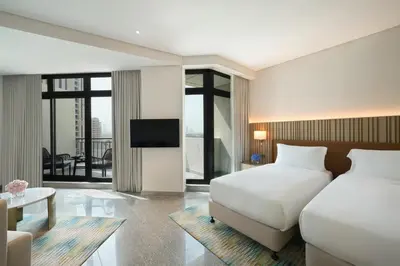a hotel room with two beds and a television at Arabian Park Dubai, an Edge by Rotana Hotel in Dubai