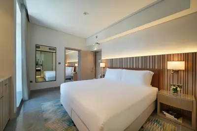 a large white bed in a hotel room at Arabian Park Dubai, an Edge by Rotana Hotel in Dubai