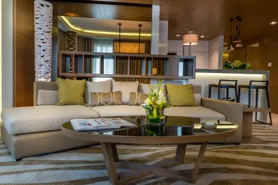 a living room with a couch and a table at Towers Rotana - Dubai in Dubai
