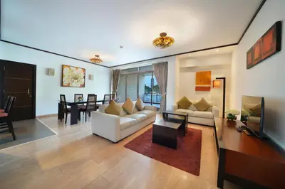 a living room with a white couch and a table at Park Apartments Dubai, an Edge By Rotana Hotel in Dubai