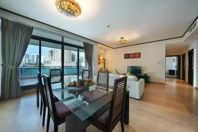 a living room with a dining table and a couch at Park Apartments Dubai, an Edge By Rotana Hotel in Dubai