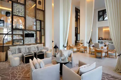 a lobby with couches and chairs and a bar at Hotel Boulevard, Autograph Collection, Downtown Dubai in Dubai