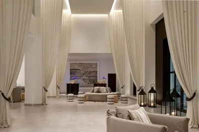 a large living room with a bed and curtains at Hotel Boulevard, Autograph Collection, Downtown Dubai in Dubai