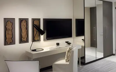 a room with a desk with a television and a chair at Hotel Boulevard, Autograph Collection, Downtown Dubai in Dubai
