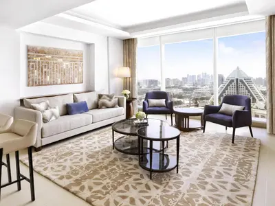 a living room with a couch and chairs at Sofitel Dubai The Obelisk in Dubai