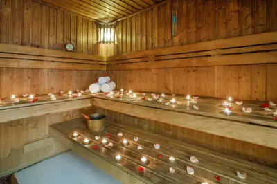 a row of wooden benches in a sauna with candles at Grand Excelsior Hotel Bur Dubai in Dubai