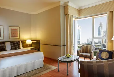 a hotel room with a bed and a large window at Millennium Plaza Downtown, Dubai in Dubai