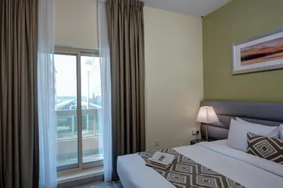 a hotel room with two beds and a window at Radiance Premium Suites in Dubai