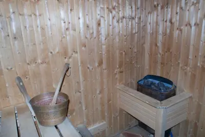 a room with a bucket and a wooden wall at Radiance Premium Suites in Dubai