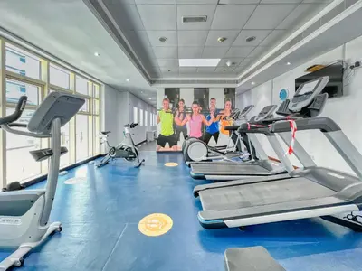 a group of people in a gym with cardio equipment at The Smart Concierge - Royal Oceanic in Dubai