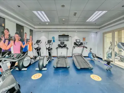 a gym with several treadmills and cardio machines at The Smart Concierge - Royal Oceanic in Dubai