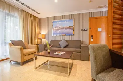 a living room with a couch and chairs and a table at Dubai Marine Beach Resort & Spa in Dubai