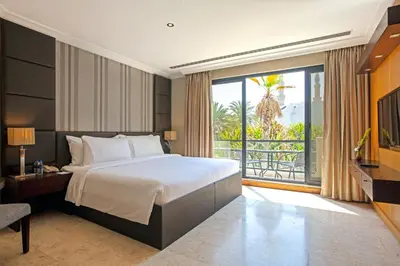 a bedroom with a large bed and a large window at Dubai Marine Beach Resort & Spa in Dubai