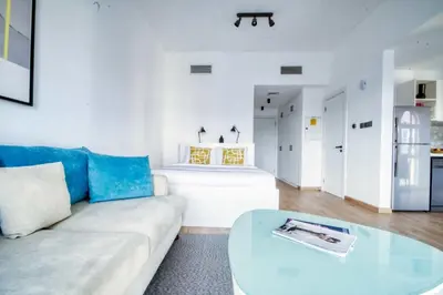 a living room with a couch and a table at The Smart Concierge - Discovery Gardens street 4 in Dubai