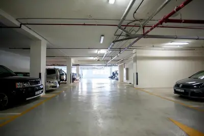 an empty parking garage with cars parked in it at Awesome Marina Canal View 1BD Bay Central Marina in Dubai