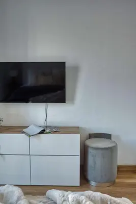 a living room with a tv on top of a dresser at The Smart Concierge - Damac Waves in Dubai