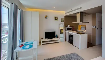 a room with a kitchen and a living room at Stylish Studio in West Avenue Dubai Marina in Dubai