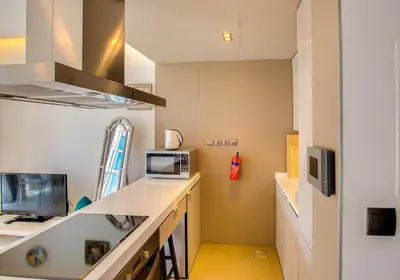 a room with a kitchen with a counter and a microwave at Stylish Studio in West Avenue Dubai Marina in Dubai