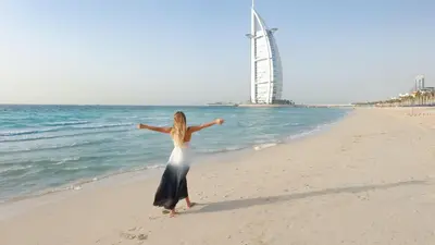 a woman in a dress standing on the beach at Holiday Inn Express Dubai Internet City by IHG in Dubai