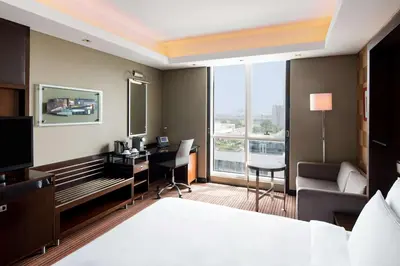 a hotel room with a bed and a desk with a computer at Radisson Blu Hotel, Dubai Media City in Dubai