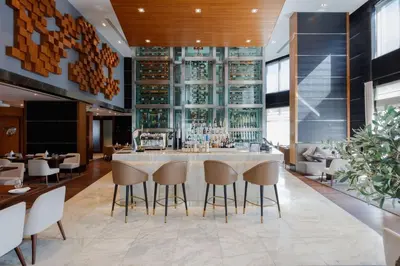 a bar in a restaurant with chairs and tables at Radisson Blu Hotel, Dubai Media City in Dubai