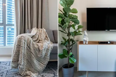 a living room with a tv and a chair at The Smart Concierge - Bay Central in Dubai