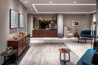 a living room with a couch and a table at DoubleTree by Hilton Dubai M Square Hotel & Residences in Dubai