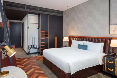 a bedroom with a large white bed in a room at DoubleTree by Hilton Dubai M Square Hotel & Residences in Dubai
