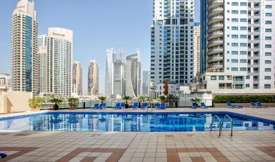 a swimming pool in a city with tall buildings at Splendid Studio in Marina View Towers in Dubai