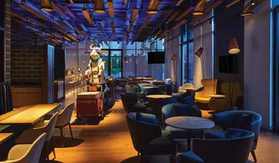 a restaurant with a cow head on the wall at Barcelo Business Bay Dubai in Dubai