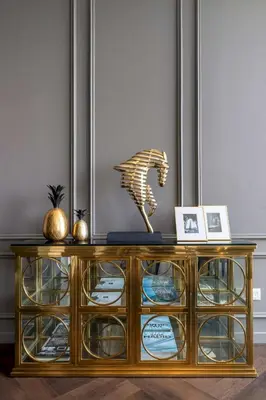 a console table with a gold lion statue on top of it at Frank Porter - Burj Vista in Dubai