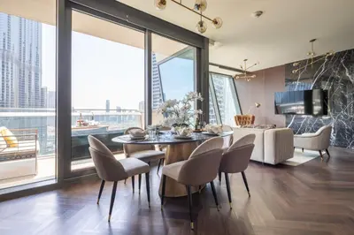 a living room with a table and chairs and a couch at Frank Porter - Burj Vista in Dubai