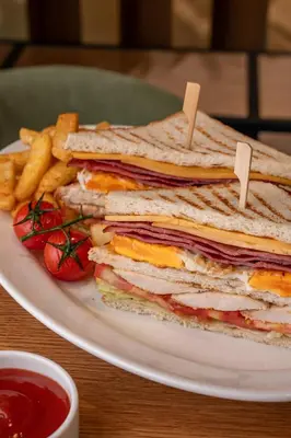 a sandwich and french fries on a plate with ketchup at Element Al Jaddaf, Dubai in Dubai