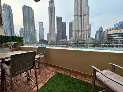a balcony with a table and chairs and a view of a city at Durrani Homes - Heaven On Earth- Burj Khalifa Fireworks in Dubai