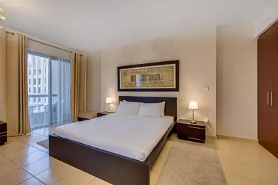 a bedroom with a large bed and a large window at Huge Sea View Studio in Murjan JBR in Dubai
