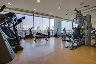 a gym with treadmills and exercise equipment in a building at MENA ApartHotel Albarsha At The Mall in Dubai