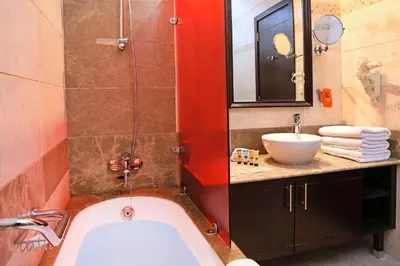 a bathroom with a bath tub and a sink at MENA ApartHotel Albarsha At The Mall in Dubai
