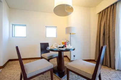a dining room with a table and two chairs at Fashion Avenue Dubai Mall-Burj Khalifa by The SHH in Dubai