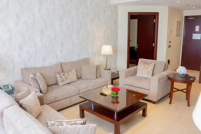 a living room with a couch and a coffee table at Grand Millennium Dubai in Dubai