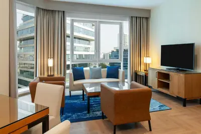 a living room with a couch and a television at Four Points by Sheraton Bur Dubai in Dubai
