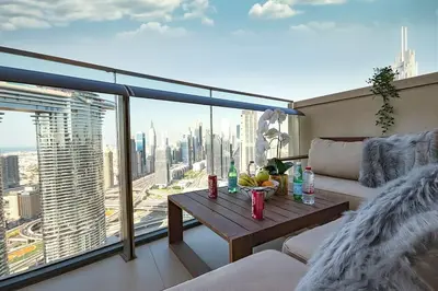 a living room with a table and a view of a city at Modern 2BR with Balcony Sea Views and Pool, Gym Near Attractions in Dubai