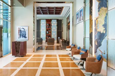 a lobby with chairs and a map on the wall at Four Points by Sheraton Sheikh Zayed Road in Dubai