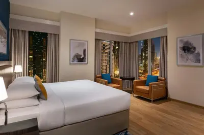 a hotel room with a bed and a city view at Four Points by Sheraton Sheikh Zayed Road in Dubai
