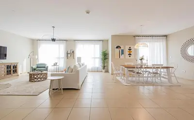 a living room with a couch and a table at Nasma Luxury Stays- Majestic Marina Views, Lavish 4BR Getaway in JBR in Dubai