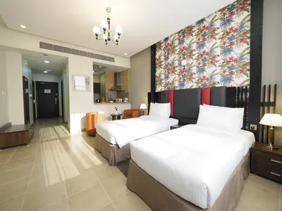 a hotel room with two beds and a wall mural at Skylark Hotel Apartments AL Barsha in Dubai
