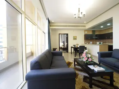 a living room with a couch and a table at Skylark Hotel Apartments AL Barsha in Dubai
