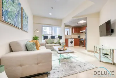 a living room with a couch and a table at Next to Lake 2BR Apartment Accessible to Metro, Dubai Gate 2, Jumeirah Lake Towers by Deluxe Holiday Homes in Dubai